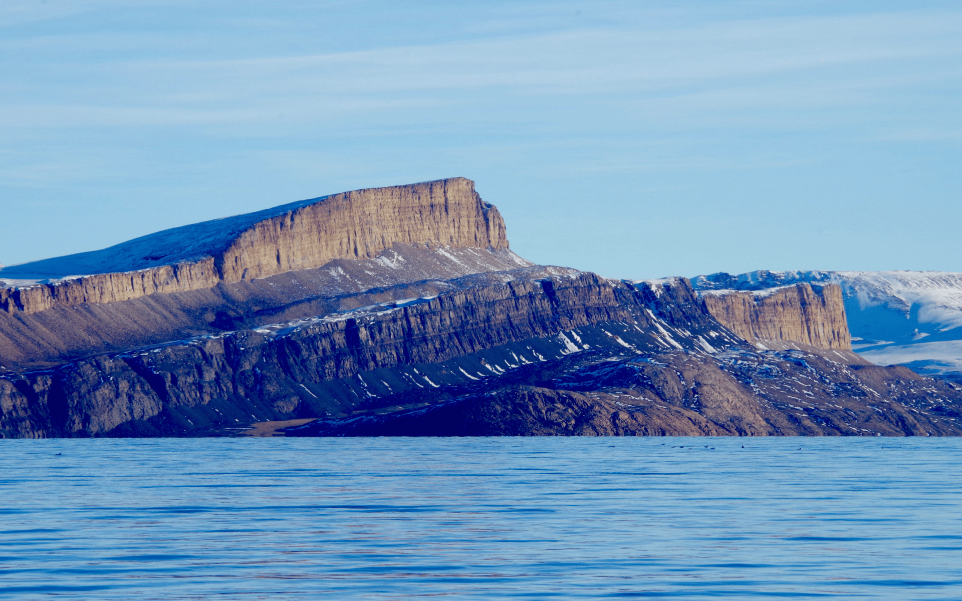 Cliffs in winter behind a large stretch of water
